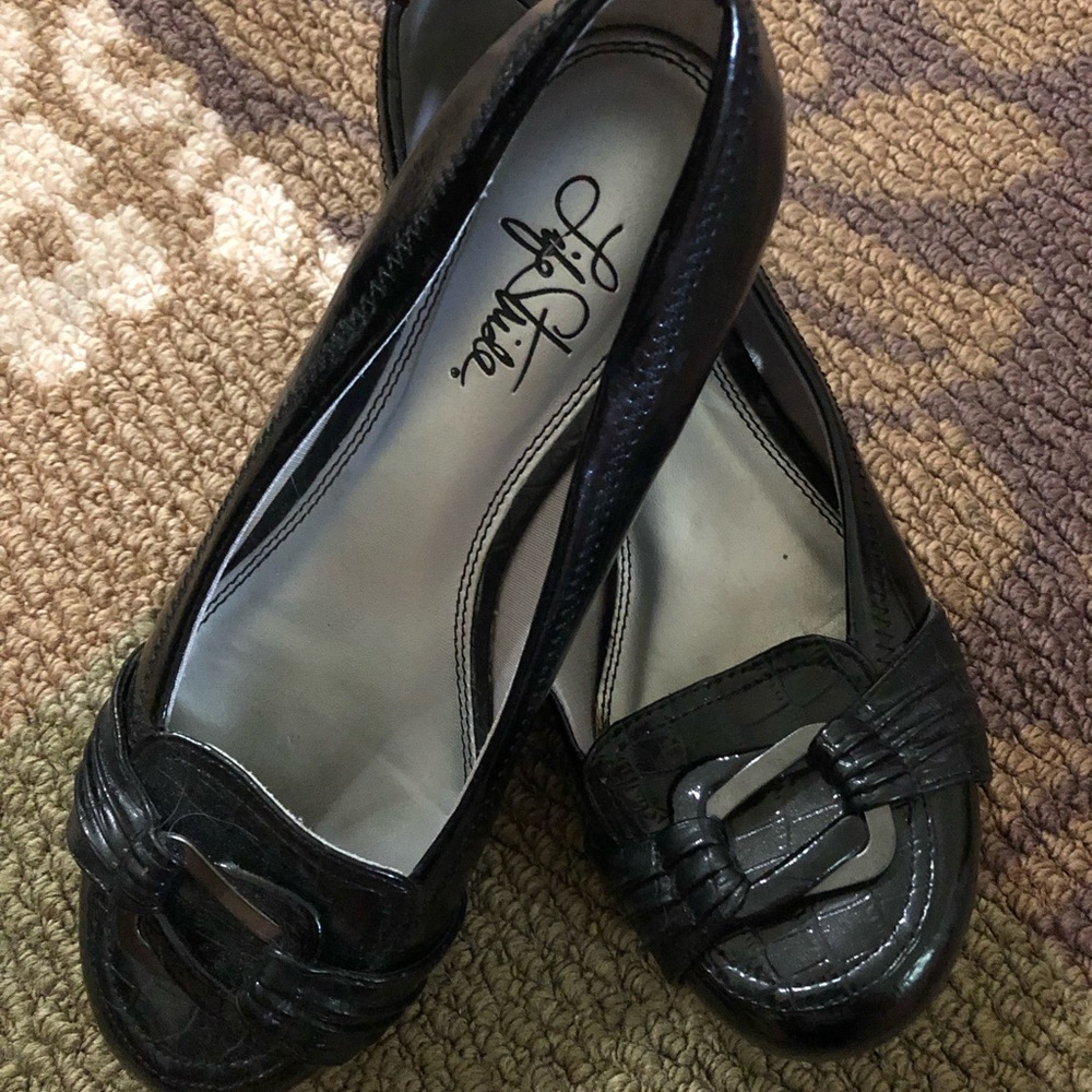 Black with silver buckle accent, loafers.